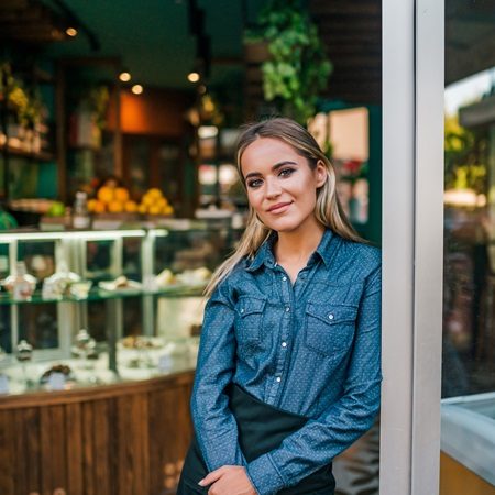 Portrait of a beautiful waitress at small business shop.